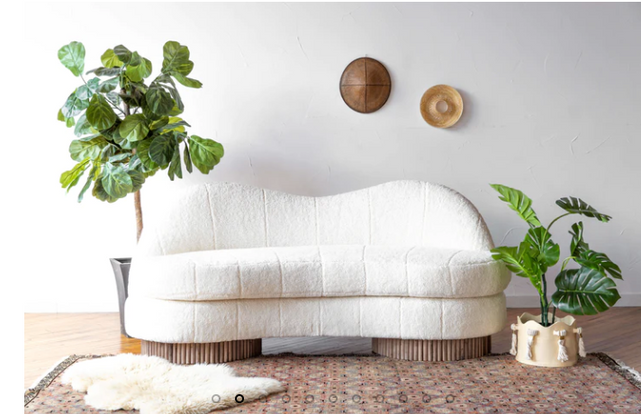 a white couch sitting in front of a rug