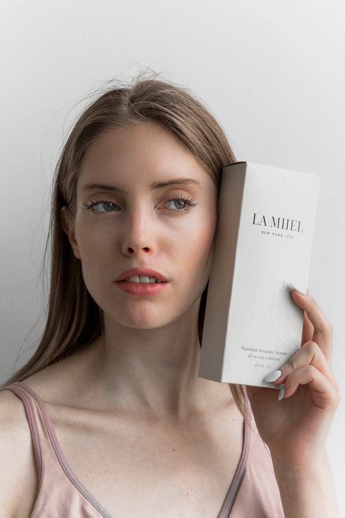 a person is holding up a box of beauty products